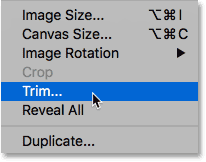 Choosing the Trim command from the Image menu in Photoshop.